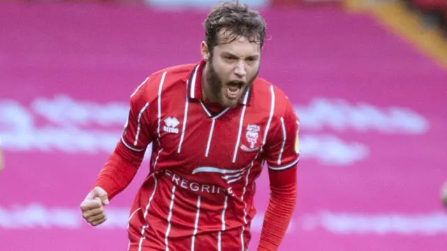 Lincoln striker Jorge Grant celebrates a goal