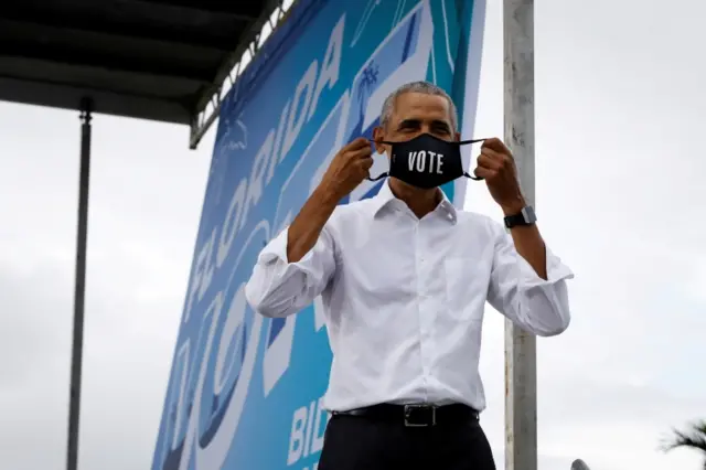 Barack Obama in a face mask that reads "vote"