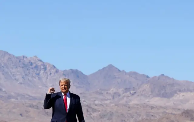 President Donald Trump raises a fist as he arrives for a campaign rally at Laughlin/Bullhead International Airport, Arizona