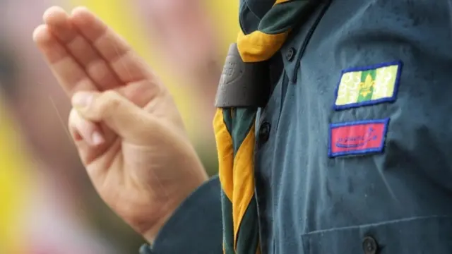 A scout making the scout symbol