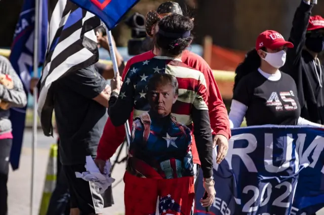 A Trump supporter wearing a t-shirt with the president's face on at the Walter Reed National Military Hospital