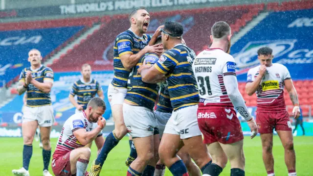 Leeds's Rhys Martin scores a try against Wigan as Luke Gale comes in top celebrate.