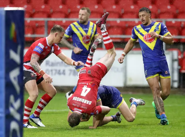 Warrington Wolves' Matty Ashton tackled by Salford Red Devils' Dan Sarginson