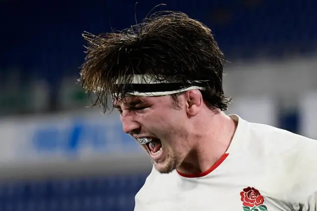 England's Tom Curry celebrates scoring a try against Italy