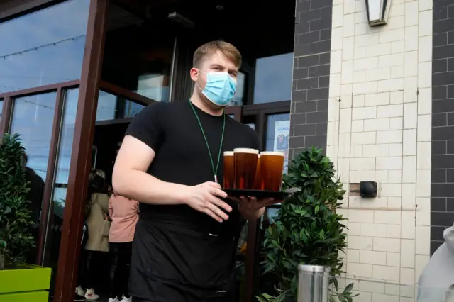 Barman carrying drinks