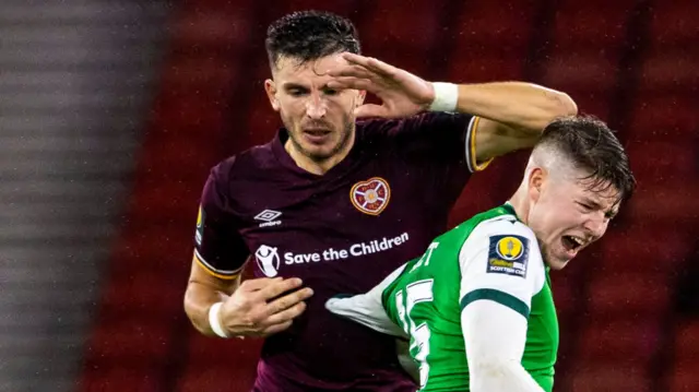 Hearts Mihai Popescu and Hibs' Kevin Nisbet