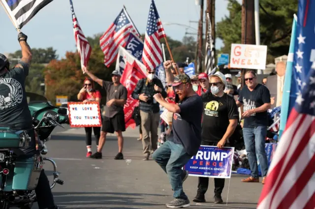 Supporters of Trump gather outside the Walter Reed hospital to show their support