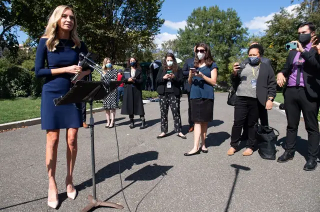 McEnany (left) has not been wearing masks during briefings, including at this one on Friday