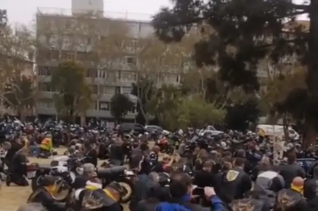 A picture showing bikers praying