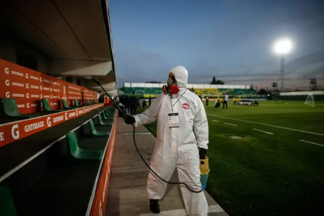 A worker disinfects areas of the stadium to avoid the spread of Covid-19, prior to a match in Group G of the Copa Libertadores, between Defensa y Justicia from Argentina and Delfin of Ecuador, in Florencio Varela, Argentina, 17 September 2020