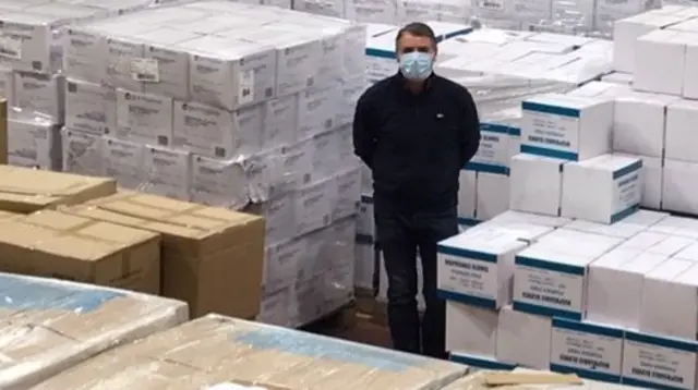 Man among stacks of PPE