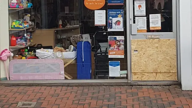 Smashed door to charity shop