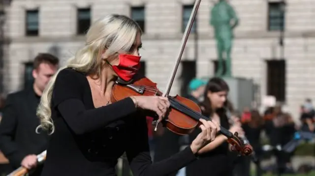 A violinist playing as part of a protest