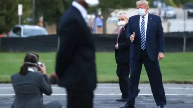 Donald Trump poses for photographers after leaving hospital