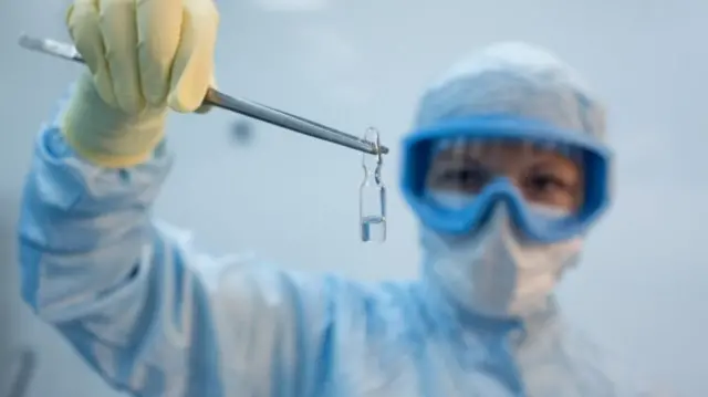 A handout photo shows an employee demonstrating a vial with "Gam-COVID-Vac" vaccine against the coronavirus disease in Russia