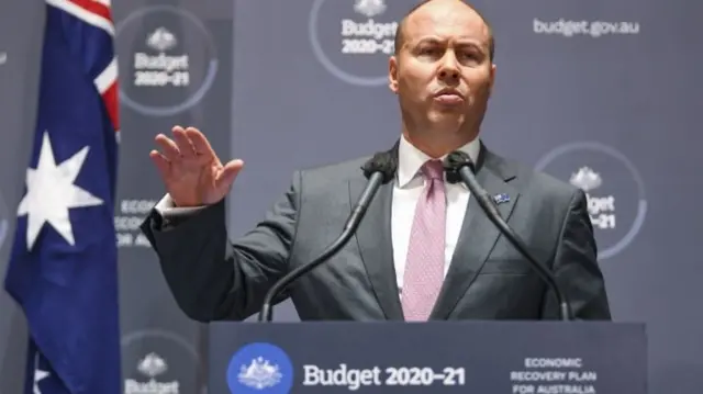 Australian Treasurer Josh Frydenberg speaks to the media