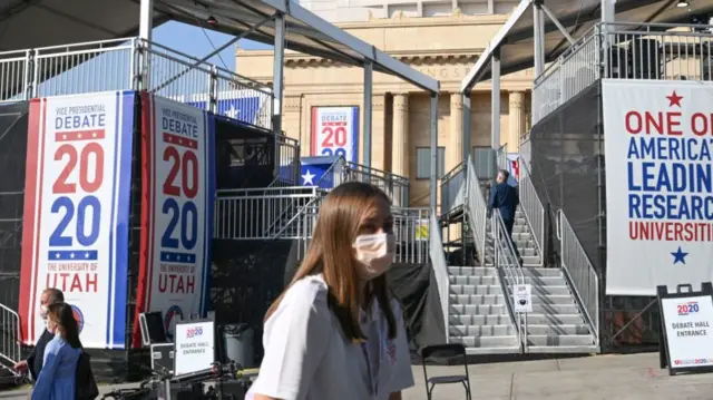 A woman in a mask outside Kingsbury Hall