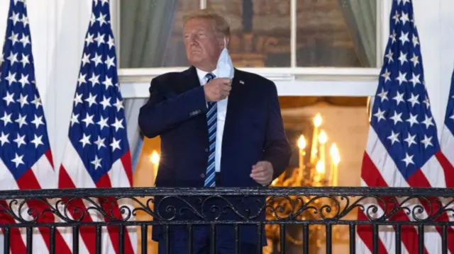 Donald Trump removes his mask at the White House