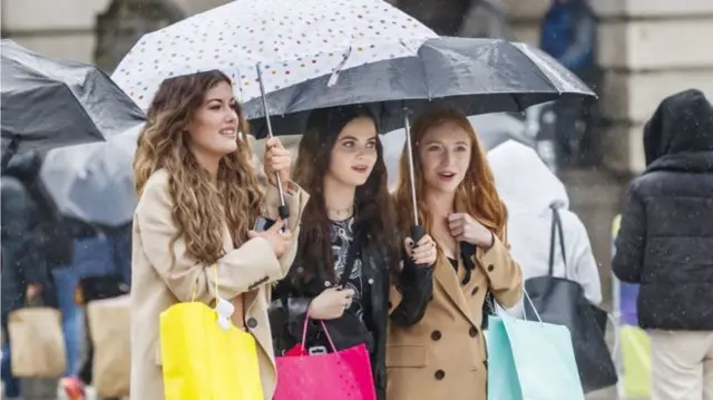 Women holding umbrellas