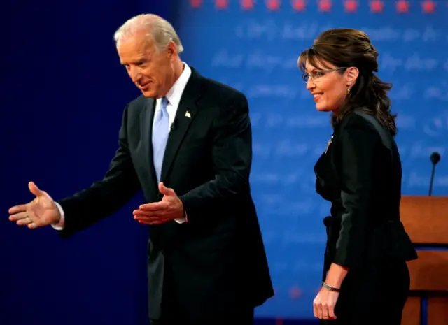 Democratic vice presidential nominee Senator Joe Biden (D-DE) (L) and Republican vice presidential nominee Alaska Governor Sarah Palin appear onstage during the vice presidential debate at Washington University in St. Louis, Missouri October 2, 2008.