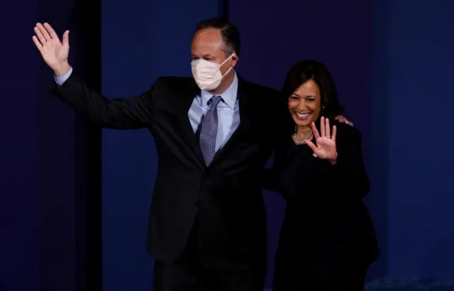 Doug Emhoff, Harris' husband, wore his mask as he took the stage