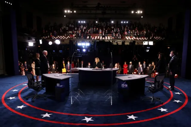 US Vice President Mike Pence, his wife Karen Pence, the Democratic vice presidential nominee and U.S. Senator Kamala Harris and her husband Douglas Emhoff are seen on the stage at the end of the 2020 vice presidential debate moderated by Susan Page of USA Today, on the campus of the University of Utah in Salt Lake City, Utah, U.S., October 7, 2020