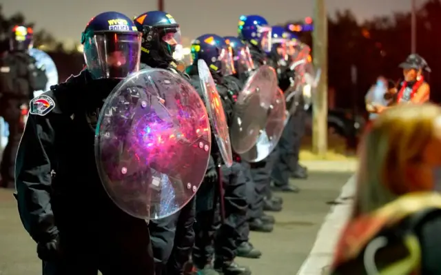 Salt Lake City police officers stood watch outside the venue in riot gear