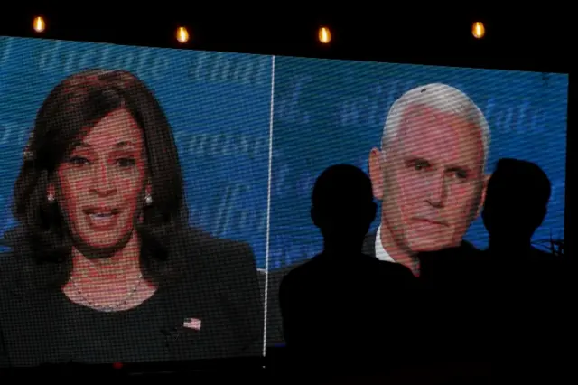 People watch the debate between Mike Pence and Kamala Harris outside a tavern in San Diego, California