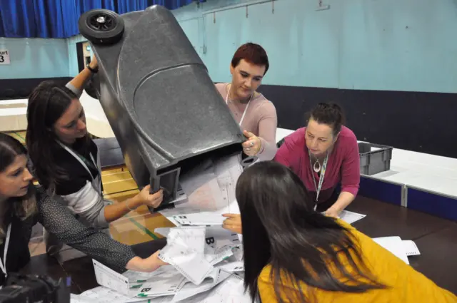 Ballot bins being emptied