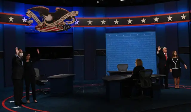 Candidates and their spouses wave at the end of the vice-presidential debate on Wednesday