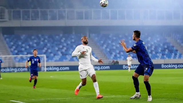 Ireland’s David McGoldrick with Martin Valjent of Slovakia