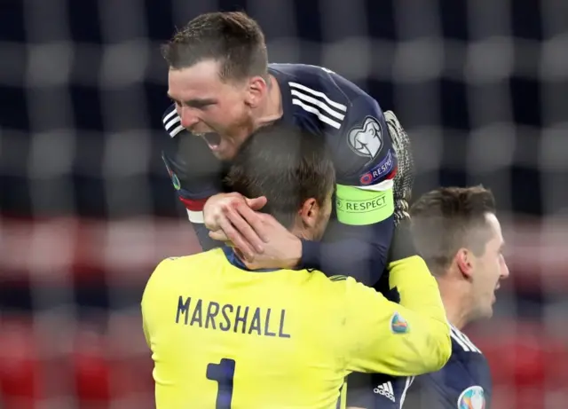 Andy Robertson celebrates with David Marshall after Scotland beat Israel