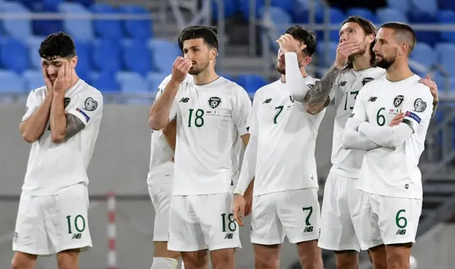 Northern Ireland players look dejected as they lose to Slovakia on penalties