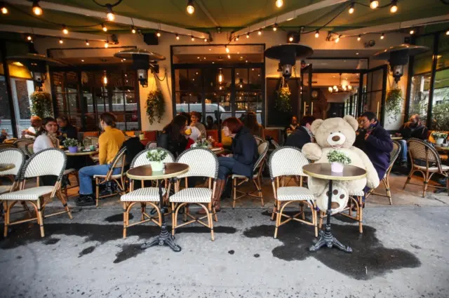 People sit in a bar terrace in Paris, France. Photo: October 2020