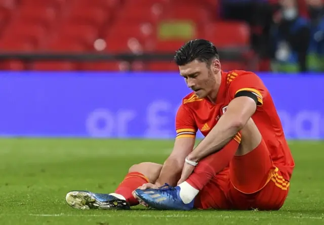 Kieffer Moore lies injured on the turf during Wales' game against England at Wembley