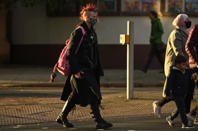 Pedestrians walk through central Nottingham