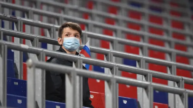 A Russian supporter awaits a friendly football match against Sweden in Moscow