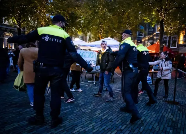 Police remove protesters from the square in front of the Dutch parliament in The Hague. Photo: 7 October 2020