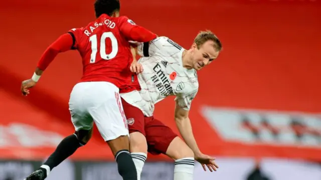 Arsenal's Rob Holding tackles Manchester United's Marcus Rashford