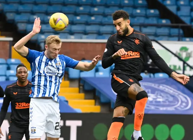 Ross Millen handles under pressure from Connor Goldson