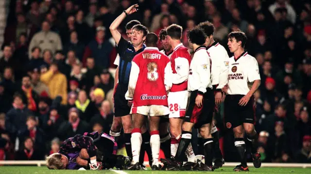 Peter Schmeichel down injured after a clash with Ian Wright in 1997