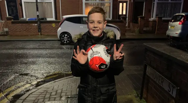 Hasan Hussein's son Ulus holds up the match ball