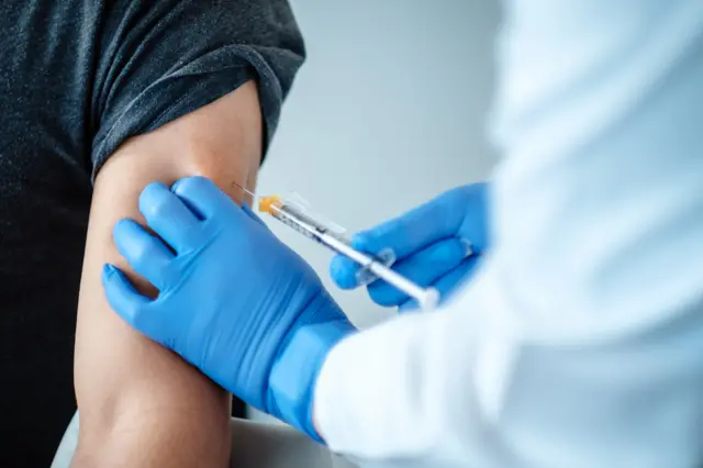 A volunteer being injected with the Pfizer-BioNTech vaccine