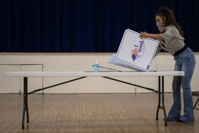 Presidio County election judge Lauren Martinez folds a booth after voting ended for the 2020 US presidential election in Marfa, Texas, November 3, 2020.