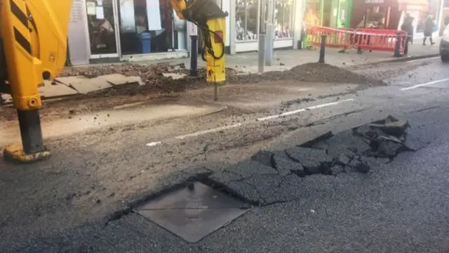 Repair work on burst water pipe on Sherrard Street in Melton Mowbray, Leicestershire