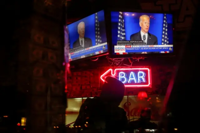 creens show Democratic 2020 U.S. presidential nominee Joe Biden delivering a speech after news media announced that he has won the 2020 U.S. presidential election, at Sam"s Tavern in Seattle, Washington, U.S., November 7