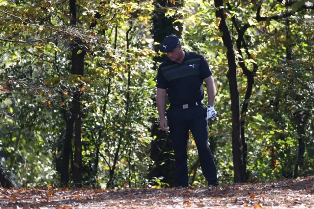 DeChambeau in the woods.
