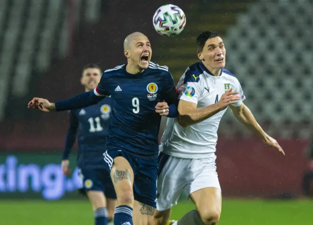 erbia's  Nikola Milenković (right) battles with Scotland's Lyndon Dykes