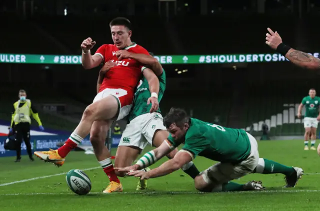 Josh Adams is stopped in his tracks by Ireland