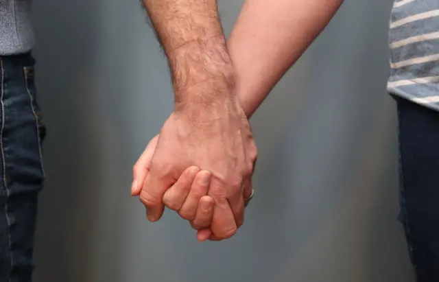 A file image of two people holding hands